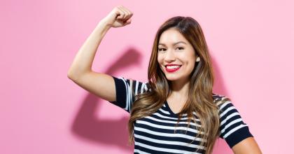 Happy young woman with arm up