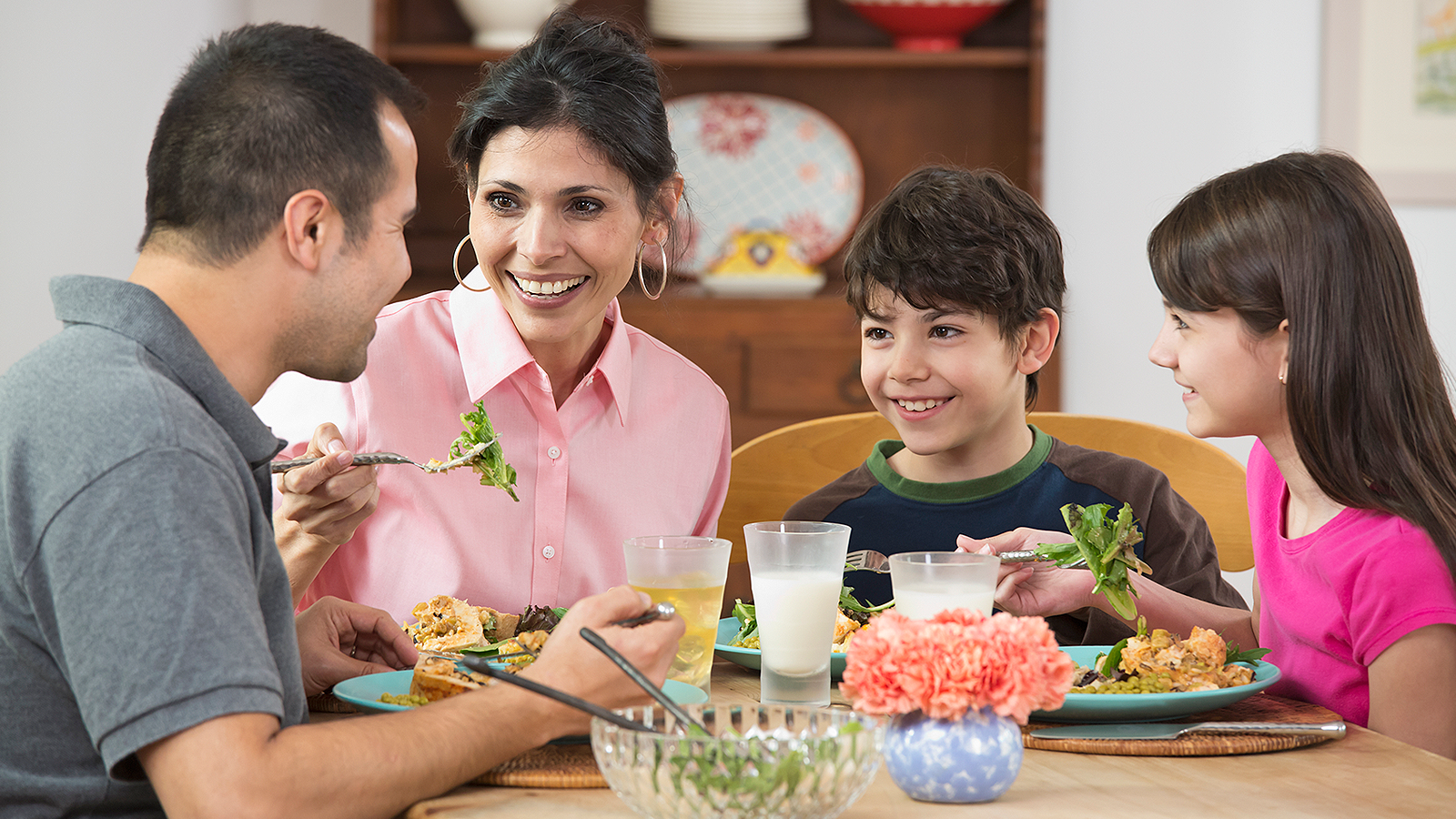 Hispanic family eating dinner together 
