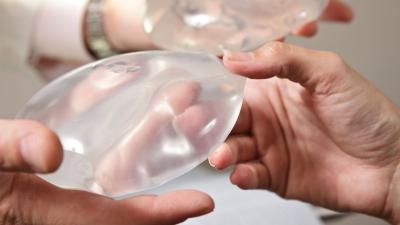 Person holding a breast implant