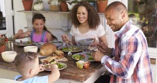 Mutual Reliance Banner of Family eating meal together