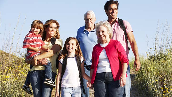 Multigenerational family walks at the beach